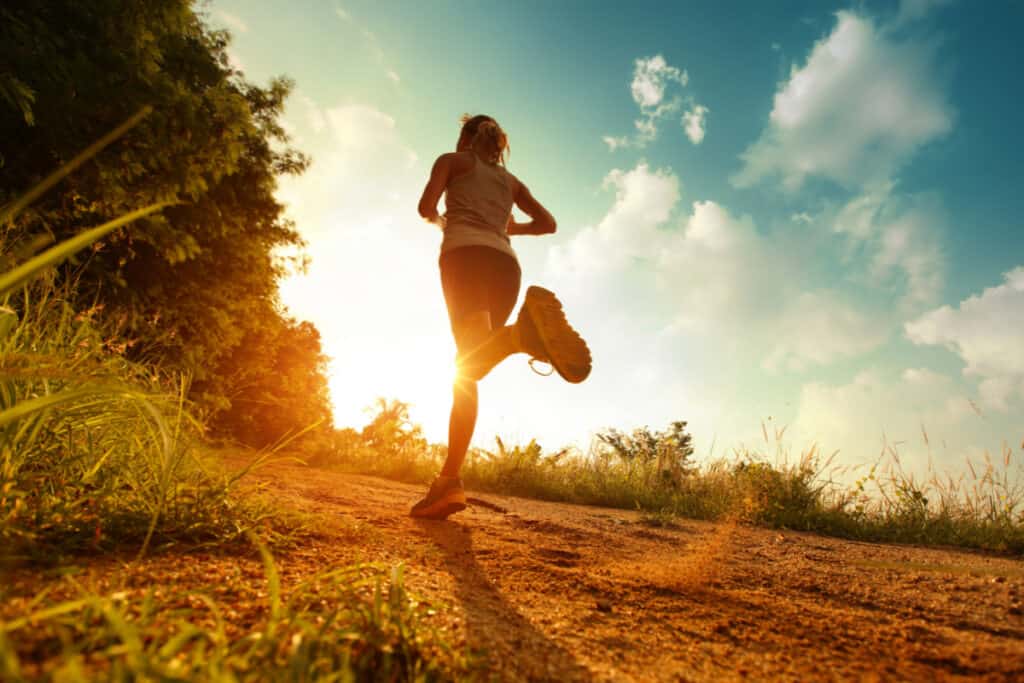 Young lady running on a rural road listening to Matt Chandler sermon